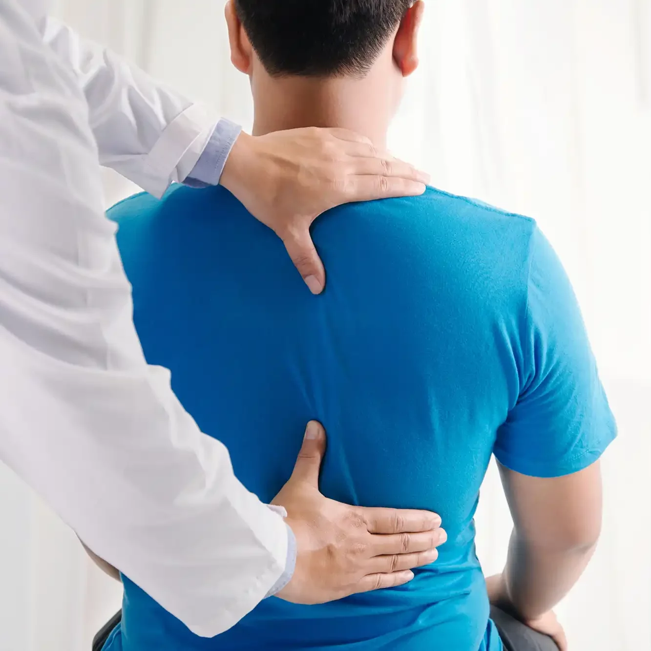 Chiropractor hands on back